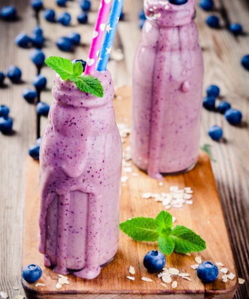 Blueberry smoothie in glass bottles